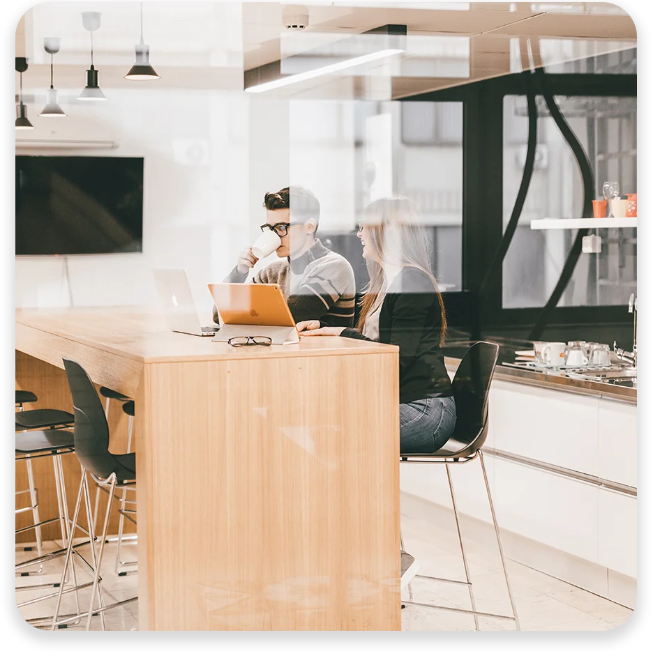 DC15 A man and woman in a conference room working and smiling.