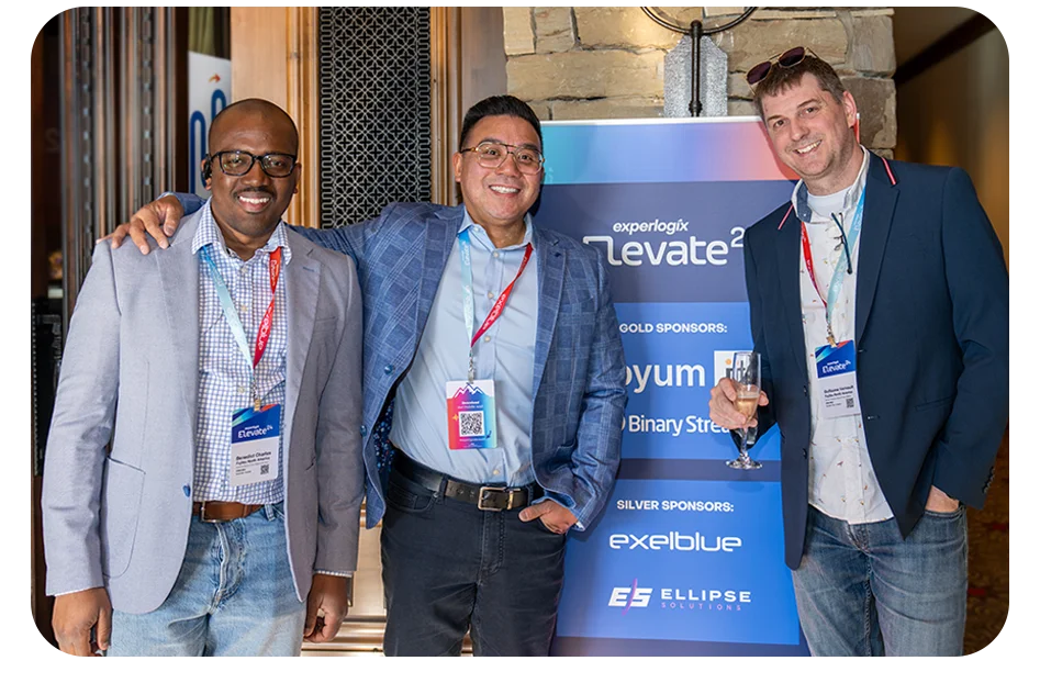 Experlogix employee and partners posing and smiling at a conference.